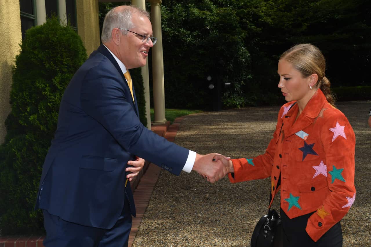 Prime Minister Scott Morrison shakes Grace Tame's hand at the Lodge.