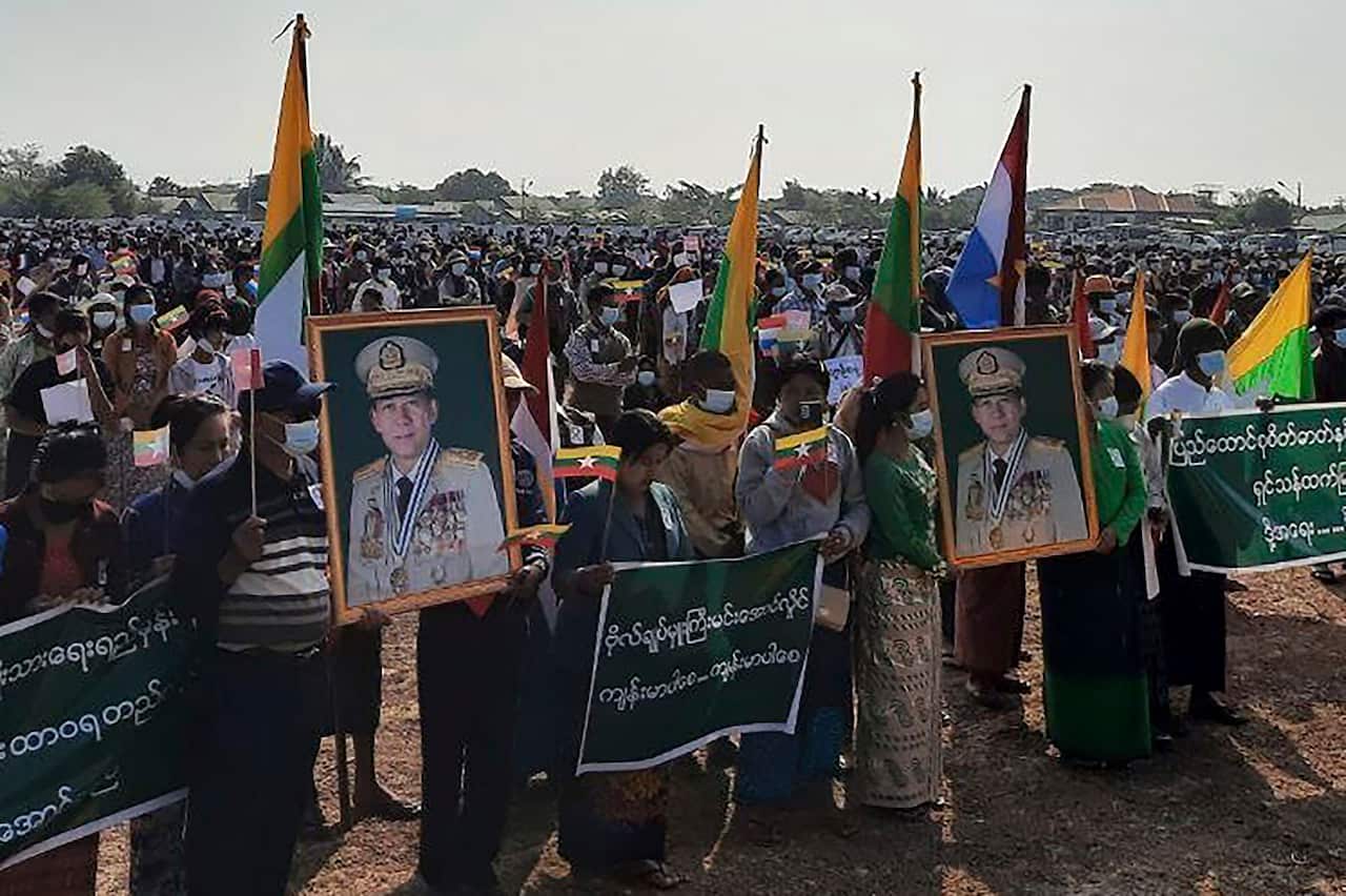 Supporters of the military government hold nationalistic banners during a rally on February 1, 2022 in Naypyitaw, Myanmar.