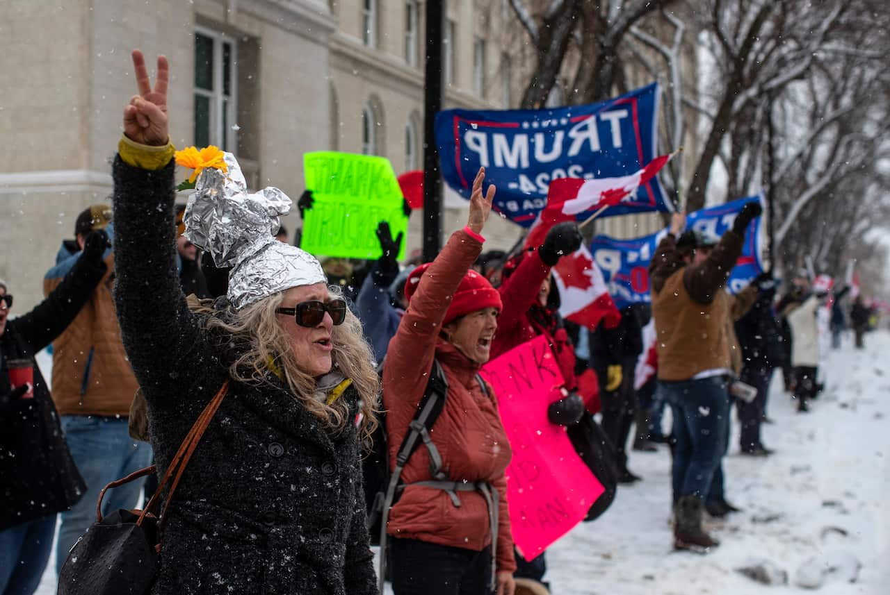 People gather in protest against COVID-19 mandates and in support of a protest against COVID-19 restrictions taking place in Ottawa, in Edmonton, Alberta, Saturday, Feb. 5, 2022. (Jason Franson/The Canadian Press via AP)