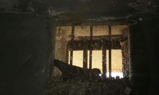 A plaster bird in the solitary confinement cell window. (Source: Elle Hardy)