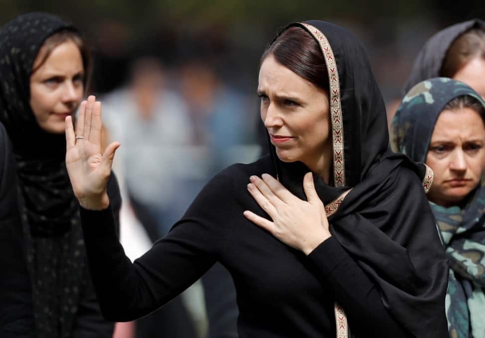 New Zealand Prime Minister Jacinda Ardern, center, waves as she leaves Friday prayers at Hagley Park in Christchurch.