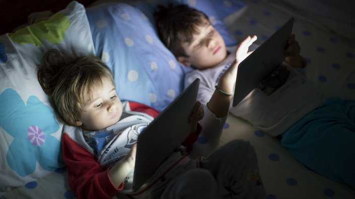 Stock photo of children on Ipads.