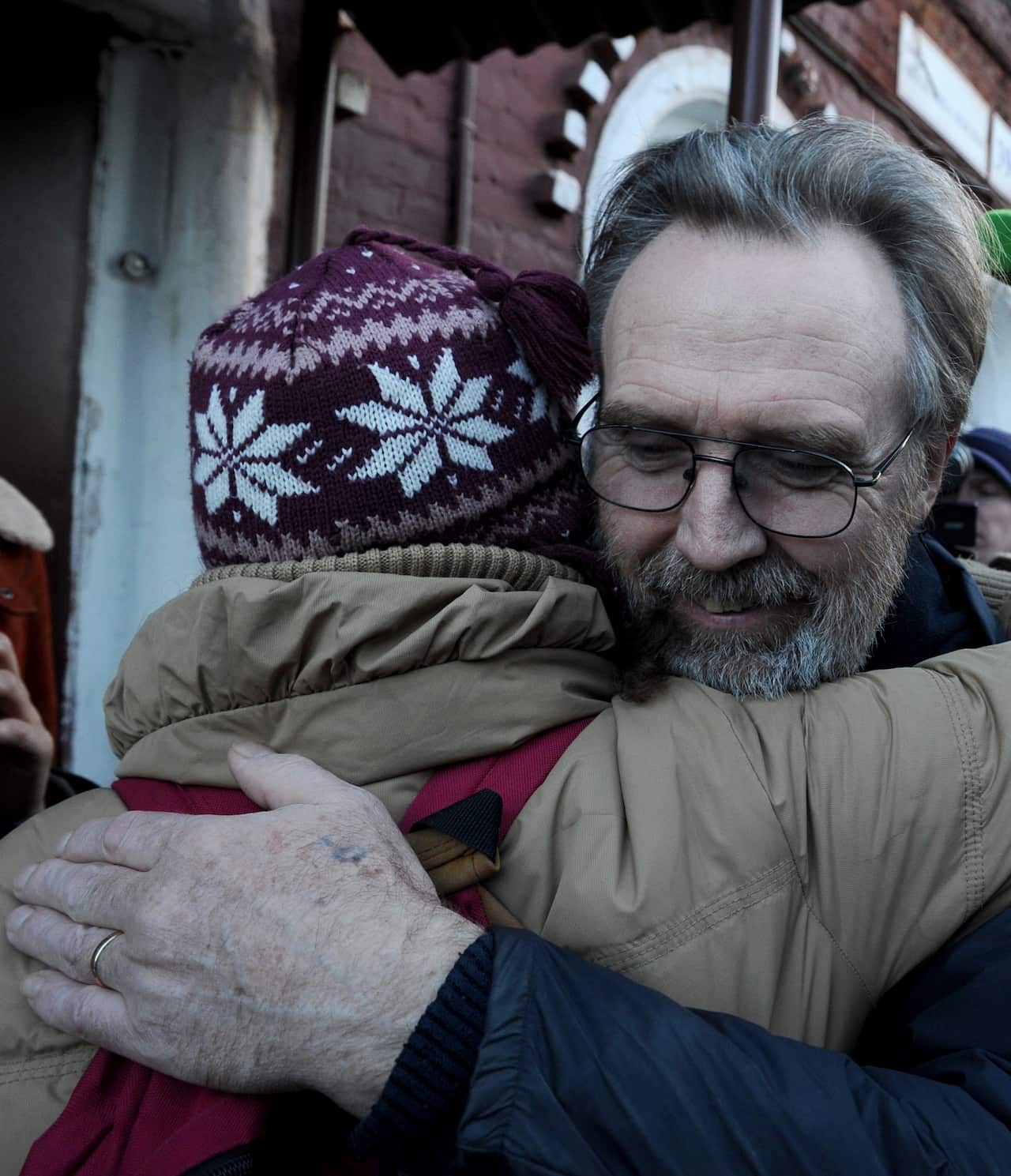 Greenpeace activist Colin Russell hugging outside Russia's SIZO detention centre