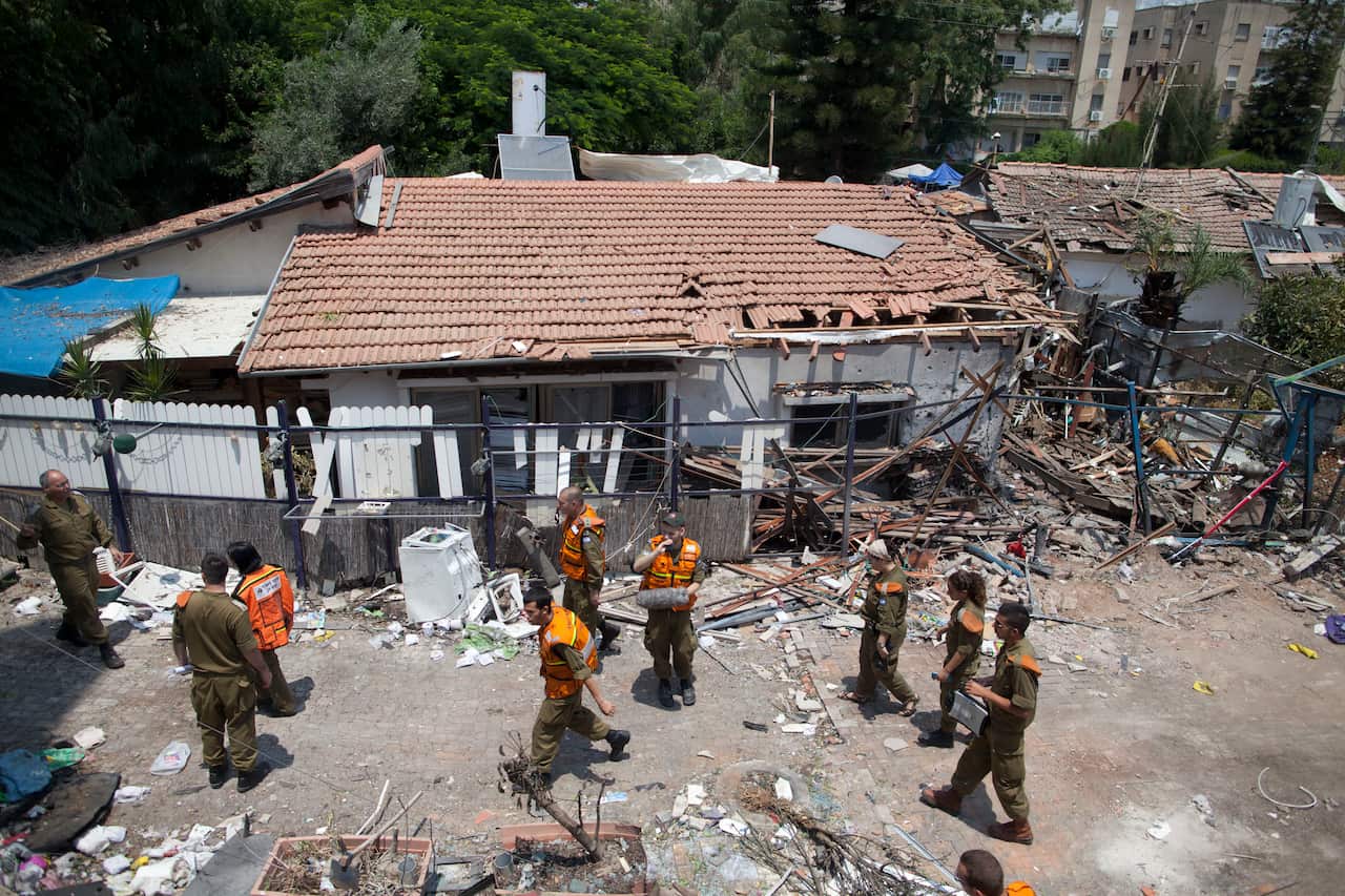 Israeli soldiers inspect an Israeli home allegedly hit by a Hamas rocket on July 22, 2014 in Yahud south to Tel Aviv (Getty)