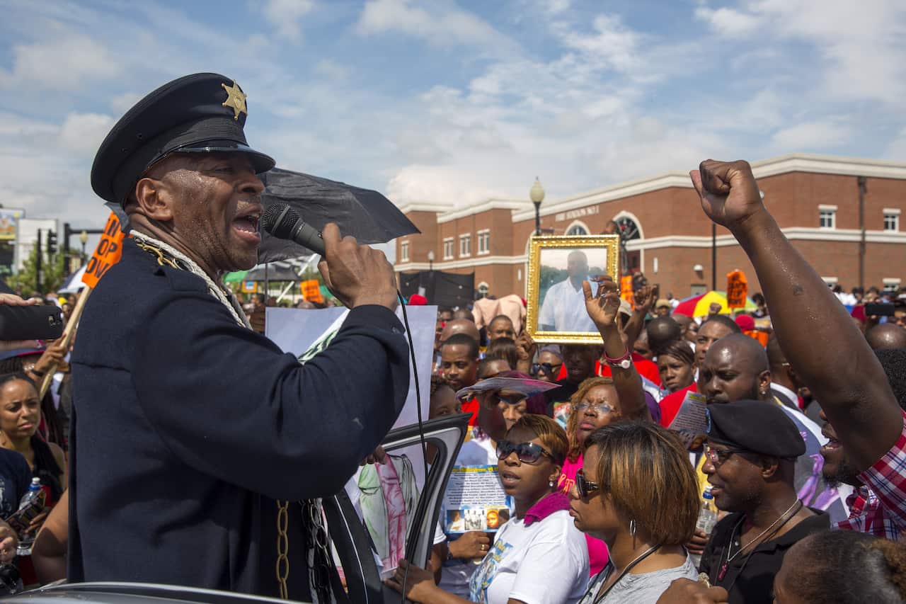 Community activist Anthony Shaheed speaks at a rally outside the police department