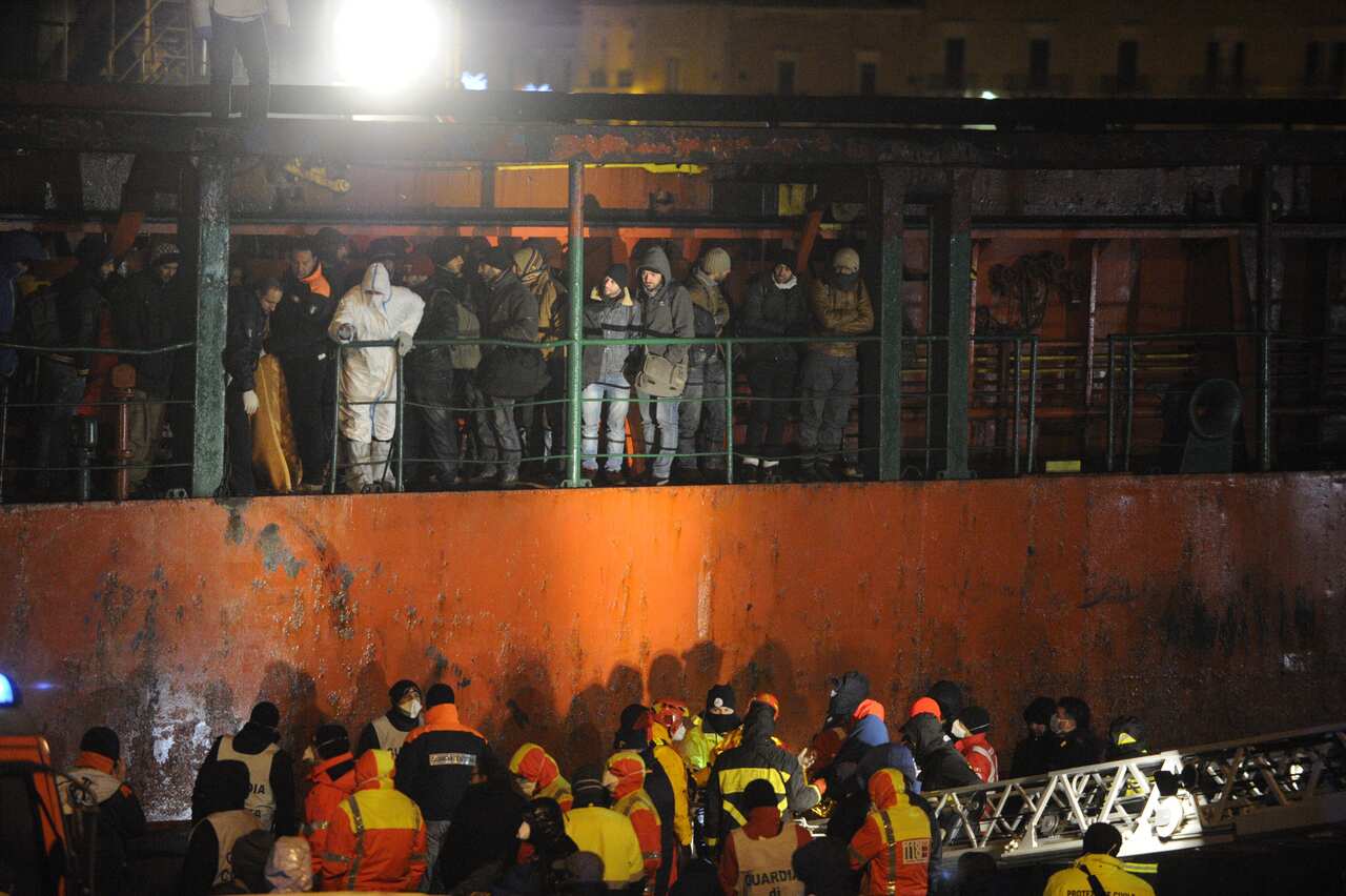 Migrants wait early on Decembre 31, 2014 aboard the Moldovan-flagged ship Blue SKy M. in the port of Gallipoli, in southeastern of Italy. (Getty)