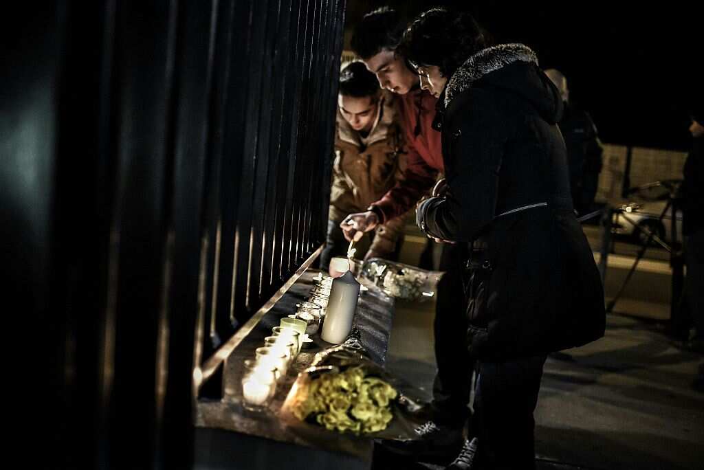 Students light candles outside the Saint-Exupery high school in Lyon, central-eastern France, on January 13, 2016, during a commemorative gathering after two students from the school and a Ukrainian man were killed when an avalanche swept away skiers in L