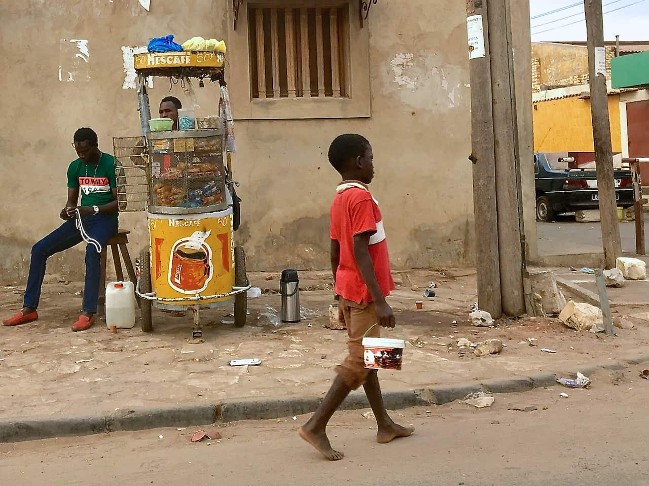 Boys often hold empty tomato cans or plastic bowls as they beg for money.