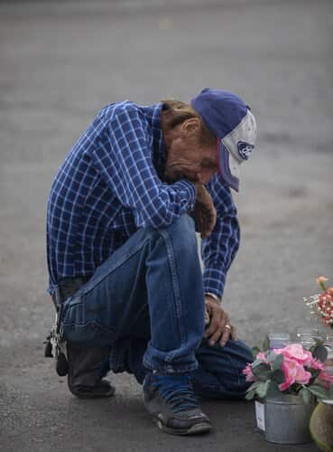 A mourner pay tribute following the El Paso mass shooting.