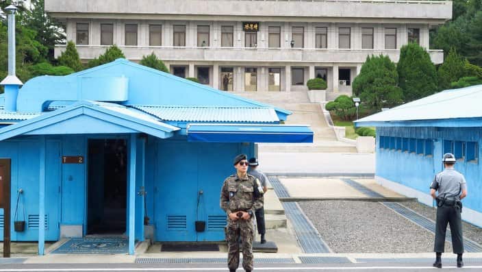 South Korean soldiers stand guard in front of North Korea's main building in a joint security area at the border village of Panmunjeom.