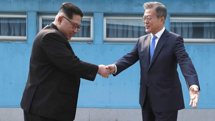 North Korean leader Kim Jong Un, left, shakes hands with South Korean President Moon Jae-in 