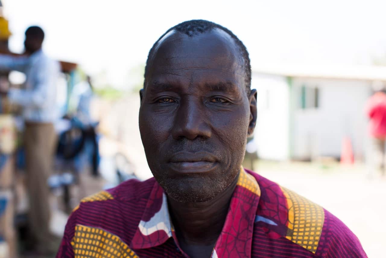 48-year-old Michael Machar and his son are both from the Nuer tribe that is the majority of 18,000 who feared attacks from the Dinka tribe and are now internally displaced people camped inside the UN base in Juba.