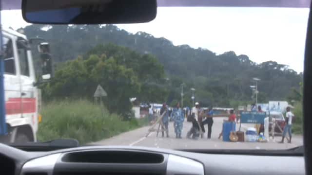 Stopping at a military checkpoint on the long drive across Sierra Leone.