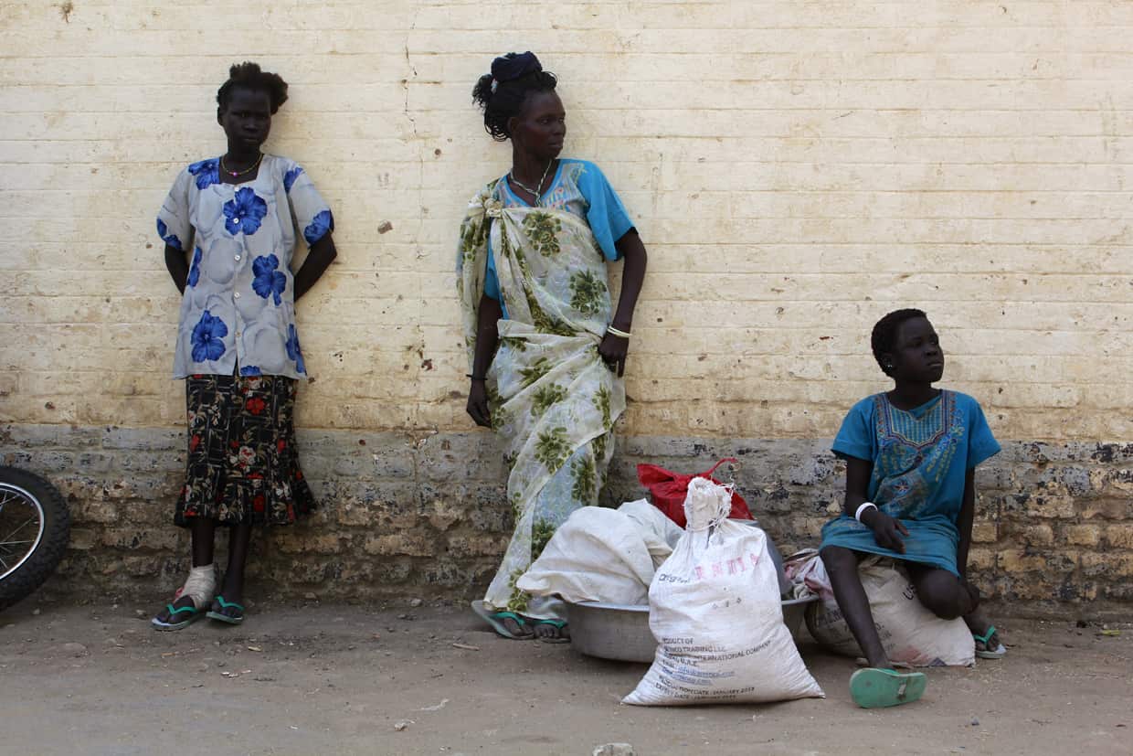 South Sudanese women stand in Malakal hospital grounds. Thousands have been squeezed into the church grounds as fighting displaces up to 500,000 people. (Source: Ilya Gridneff)