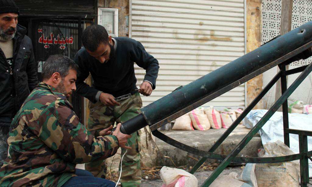 Opposition fighters load a homemade rocket launcher during clashes with government forces in the northern Syrian city of Aleppo on January 12, 2014. (AFP)