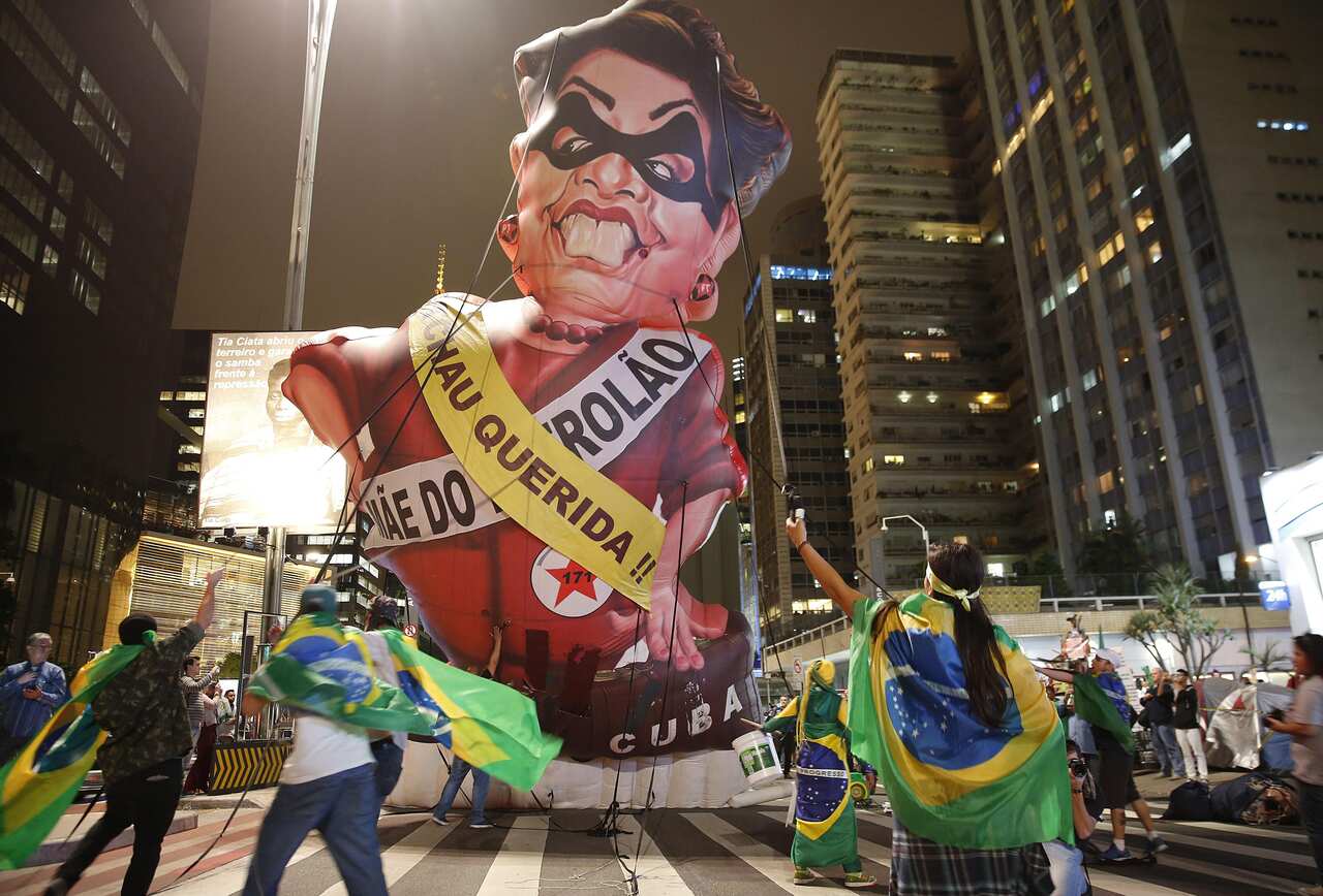 Anti-government demonstrators set up a large inflatable doll in the likeness of Brazil's President Dilma Rousseff in Sao Paolo