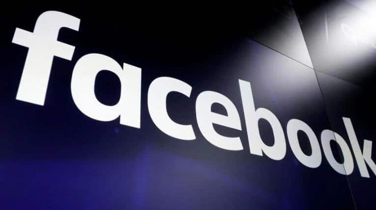 Facebook's logo is seen on a giant display monitor