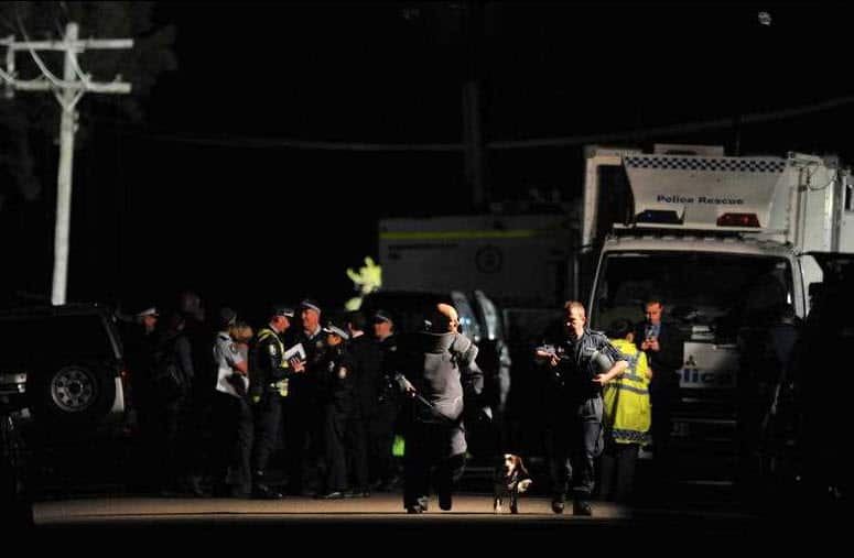 Matthew Warwick (L) walks from a home in Sydney where Bomb squad officers worked to defuse a suspicious device in 2011.