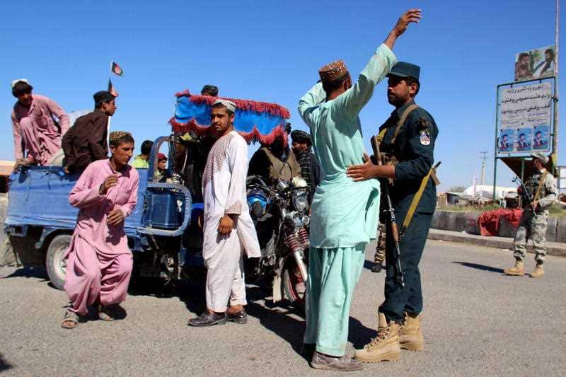 Afghan security officials check people and vehicles as security has been intensified ahead of parliamentary elections in Helmand.