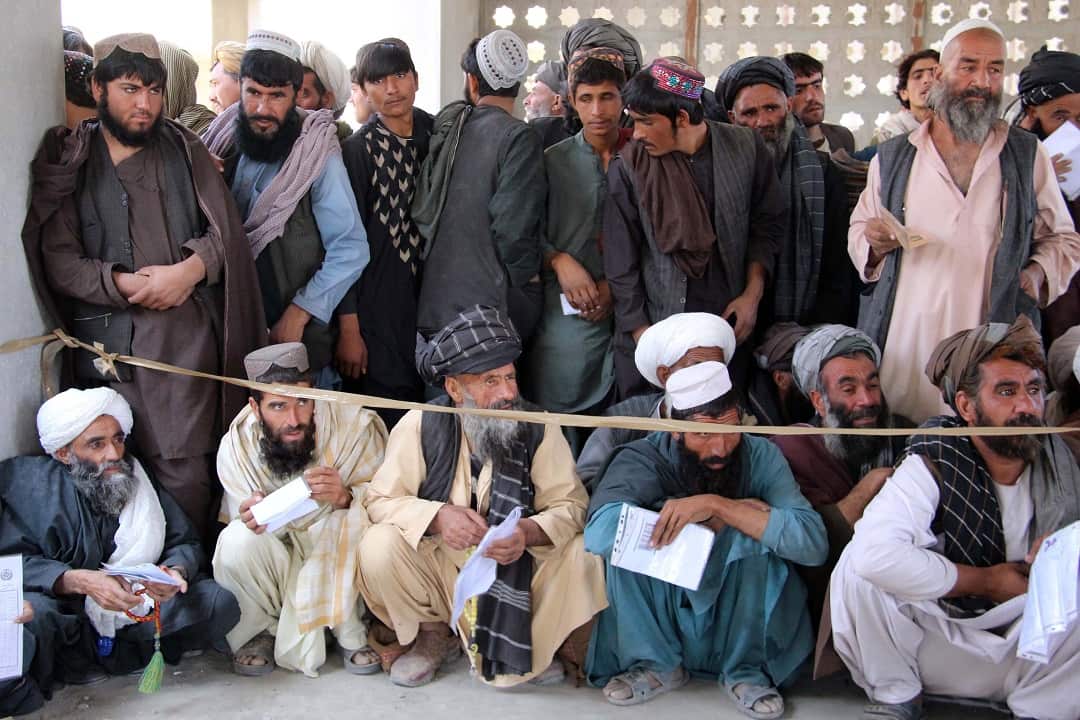Afghans wait to cast their ballot as voting continued for the second day in some polling stations in Helmand.