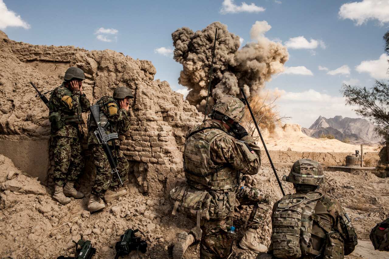 Afghan Army troops, left, and American soldiers attack a Taliban firing position in Layadira, Afghanistan, on Feb. 14, 2013. 