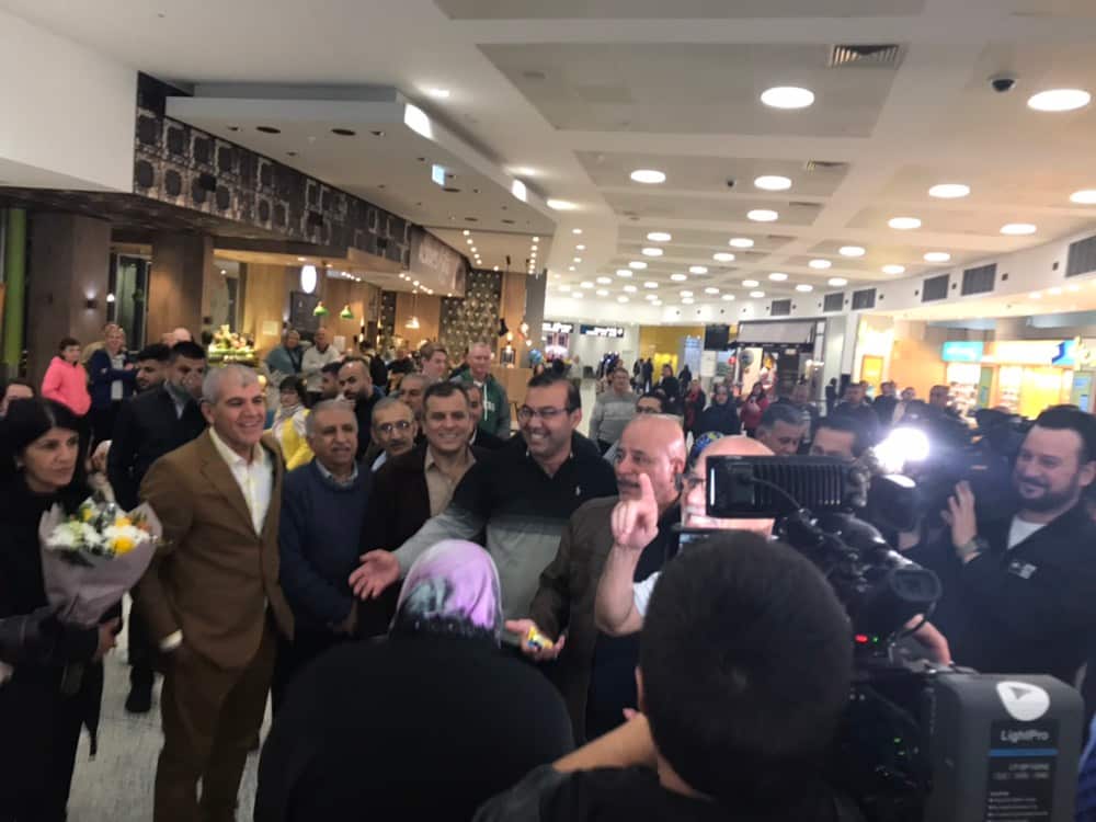 Media, friends and family greet Naim Aziz Abbas.