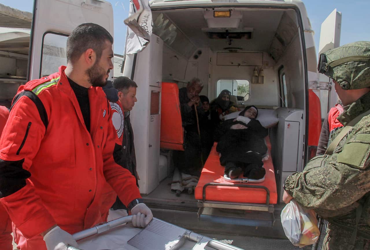 The Syrian Red Crescent and the International Red Cross help those unable to walk. 
