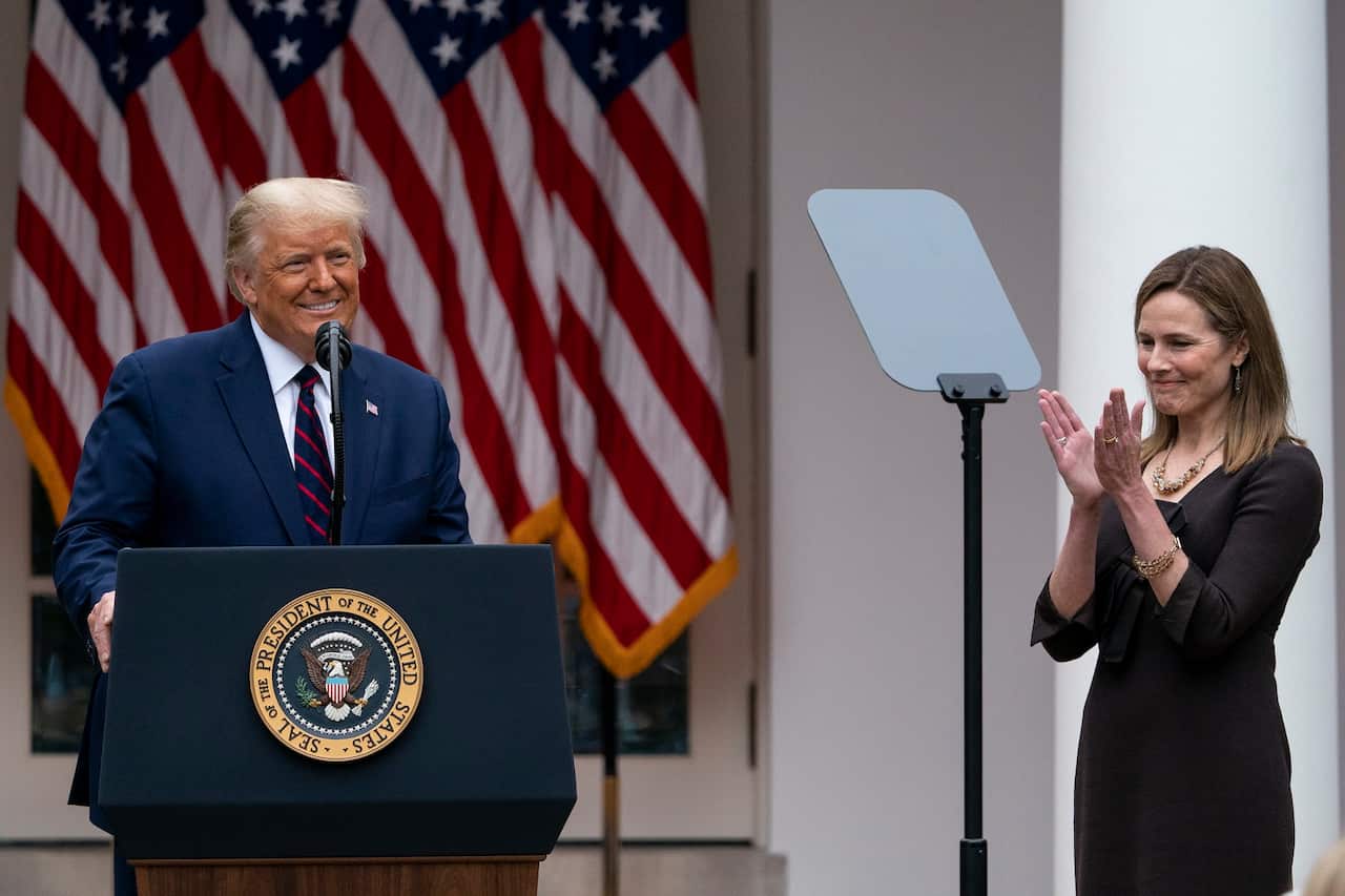 Judge Amy Coney Barrett applauds as President Donald Trump announces her as his nominee to the Supreme Court.
