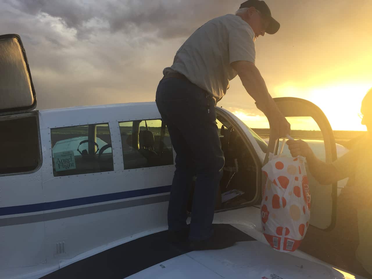 An Angel Flight Australia pilot drops off food to stranded residents.