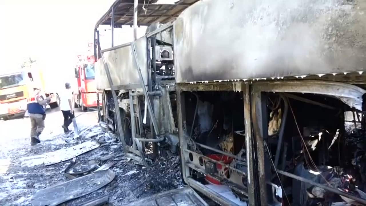 Charred suitcases under the bus