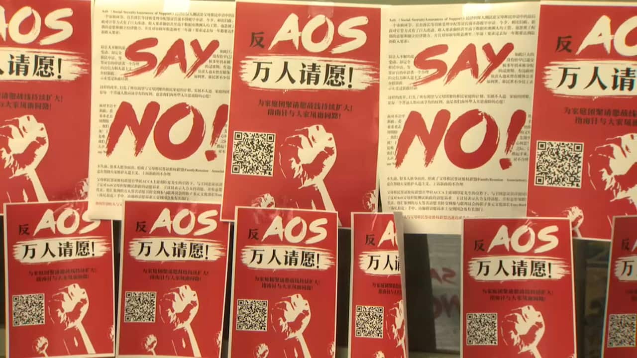 Chinese posters urging the government to overturn the changes at a weekend protest in Sydney.