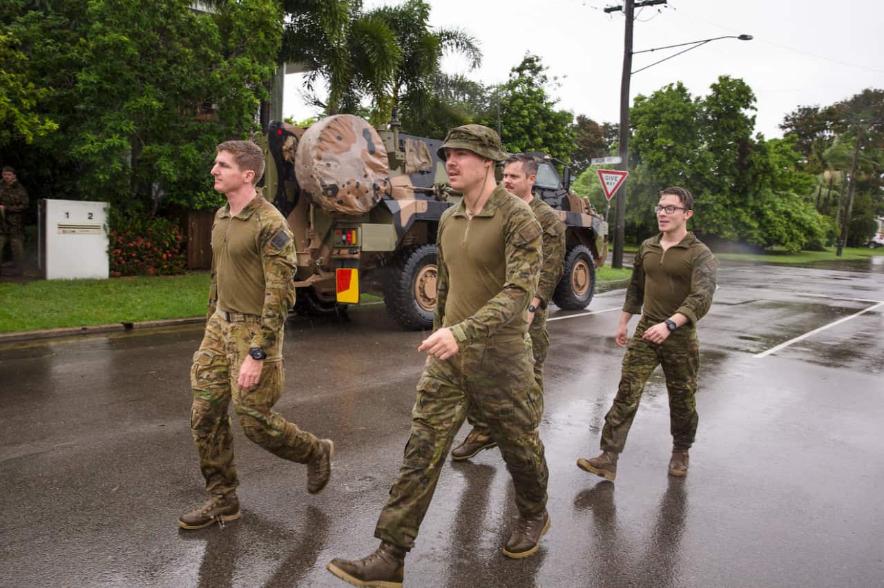 Army personal are seen assisting with flood evacuations in Rosslea, Townsville,