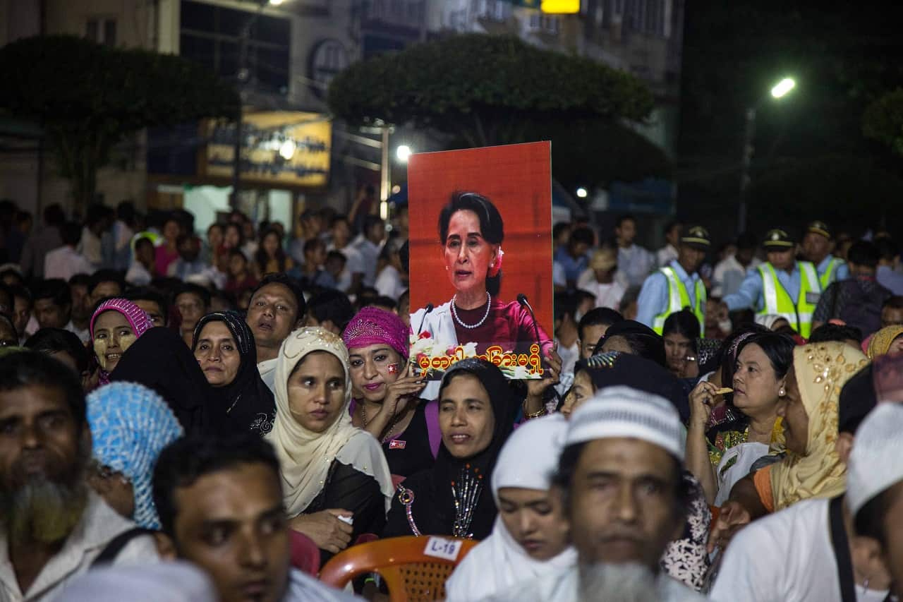 Myanmar citizens hold photos of Aung San Suu Kyi during an interfaith prayer ceremony organized by the National League for Democracy.