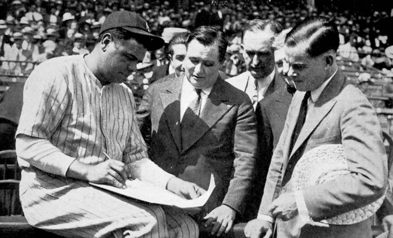 Photograph showing Babe Ruth (1895-1948), the American baseball player, signing a $100,000 contract for a twelve-week tour, 1926.