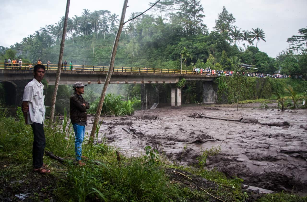 People gather on the banks of the Yeh Sah River in Karangasem Regency of Bali, Indonesia on November 28, 2017 (AAP)