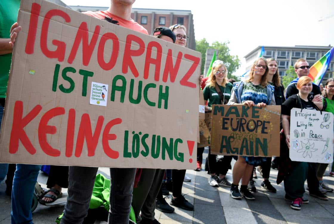 Banner at left in picture reading 'Ignorance is not a solution either.' (AAP)