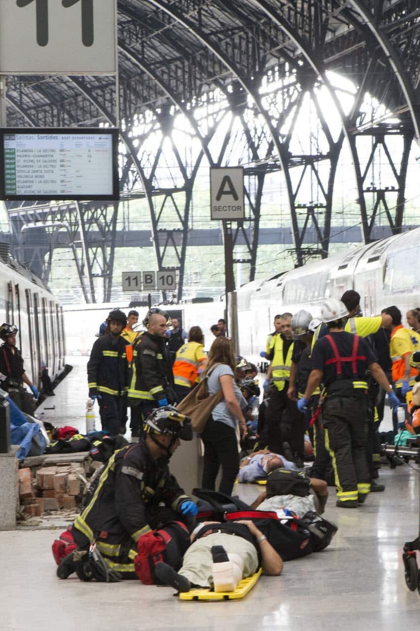 Spanish firefighters and paramedics treat injured people at Francia Railway Station in Barcelona, northeastern Spain, 28 July 2017.