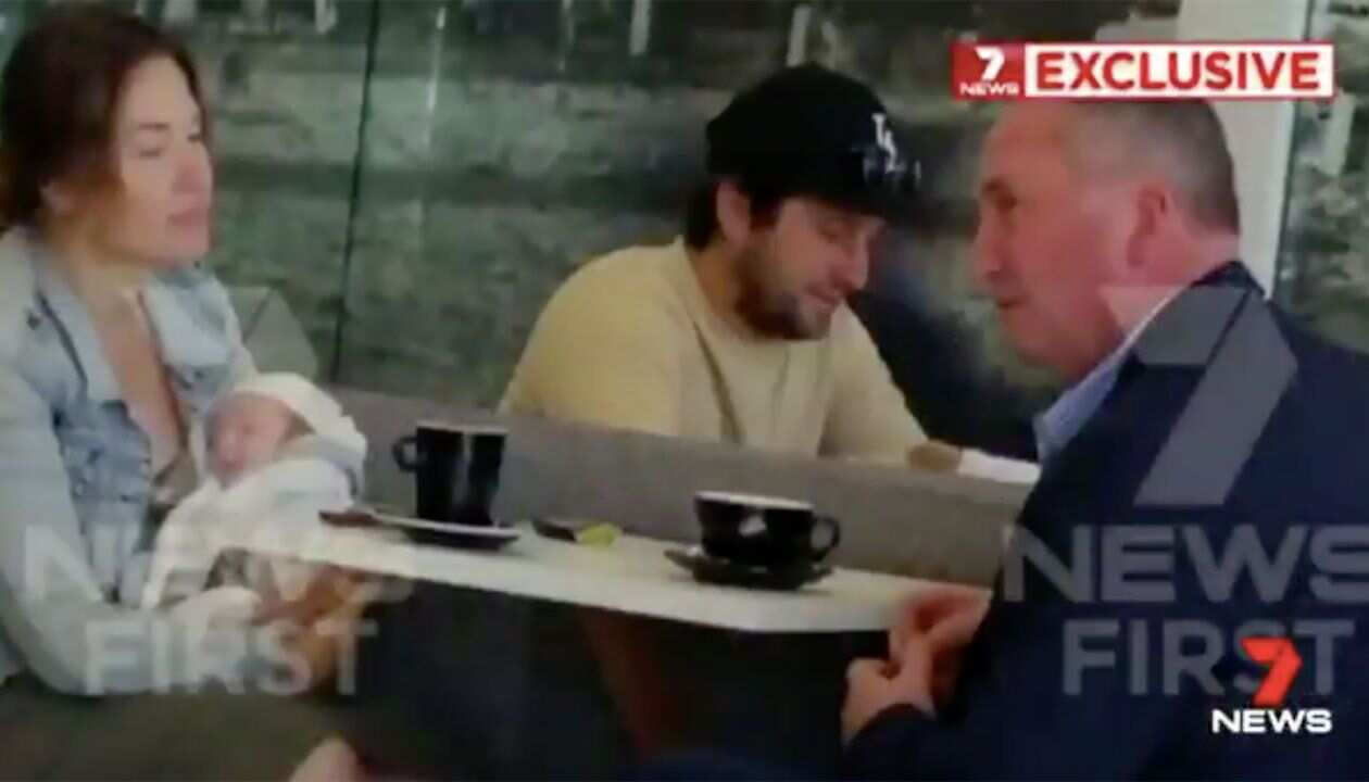 Vikki Campion holds baby Sebastian while Barnaby Joyce looks on.