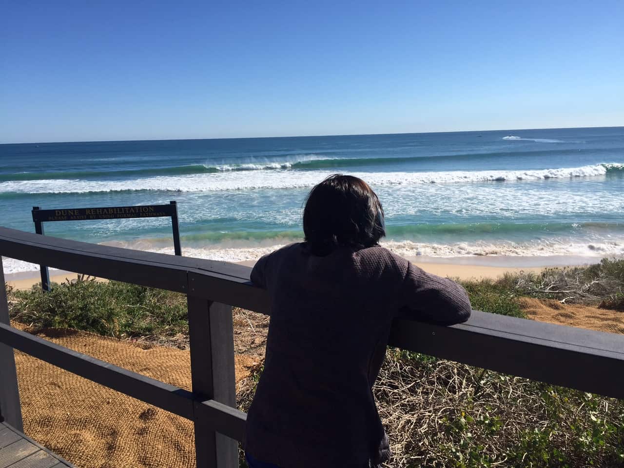 A person stands at the scene where the shark attack occurred (SBS)