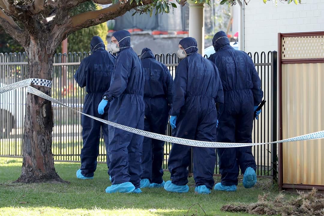 Forensic police officers inspect a property in Bedford, Perth after five bodies were discovered at the home.