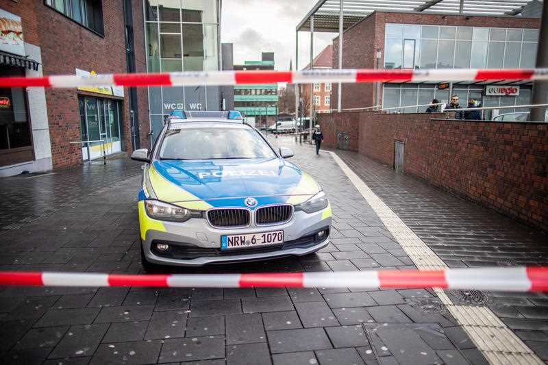 A police car stands behind barrier tape on Berlin Square after the incident.