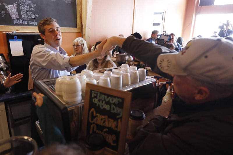 Former Texas congressman Beto O'Rourke greets an audience member during a stop at the Central Park Coffee Company.