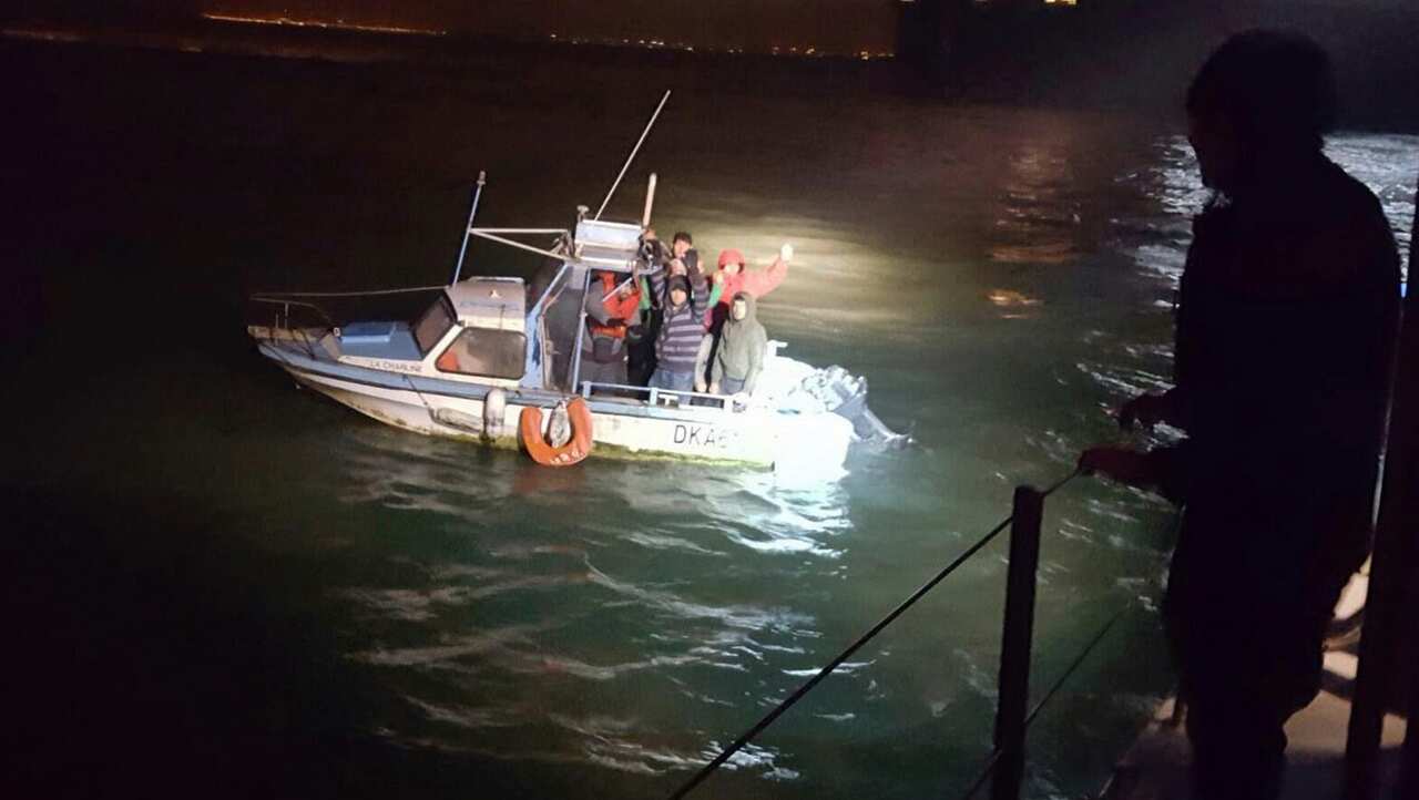 Migrants aboard a boat after being intercepted by French authorities, off the port of Dunkirk, northern France, on November 27, 2018.