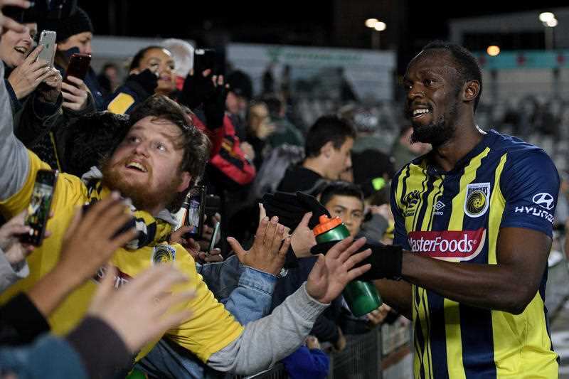 The speedy star greets fans.