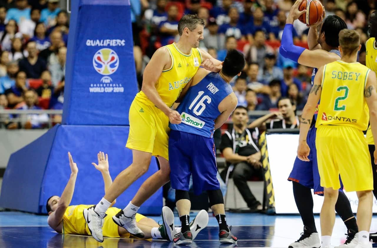 Christopher Goulding (L) lies on the ground as Daniel Kickert (2-L) of Australia elbows Roger Pogoy (C) of the Philippines 