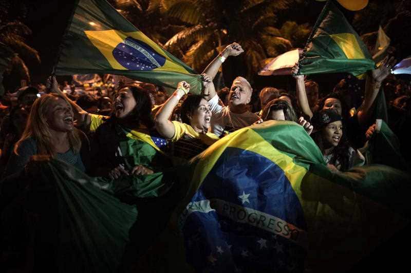 Supporters of Jair Bolsonaro celebrate in front of his residence in Rio de Janeiro.