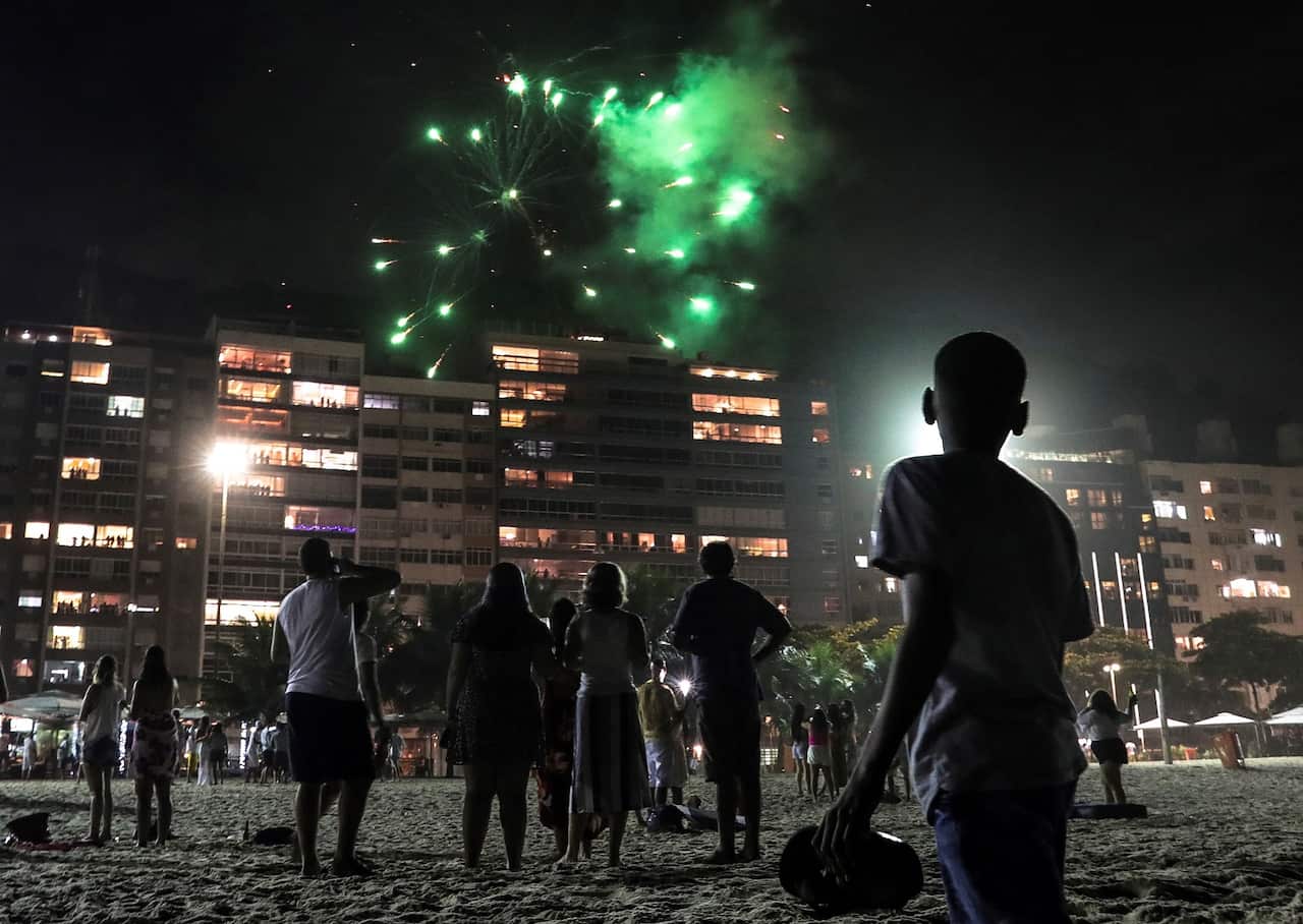 People enjoy of the end of the year celebrations at Copacabana beach in Rio de Janeiro, Brazil.