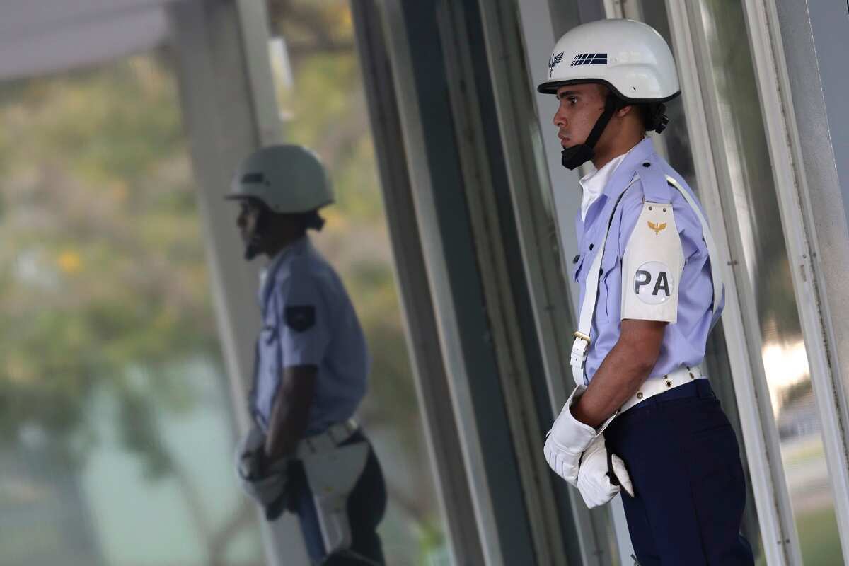 An airman of the Brazilian Air Force guards the main entrance of the headquarters of the Ministry of Defense, in Brasilia, Brazil.