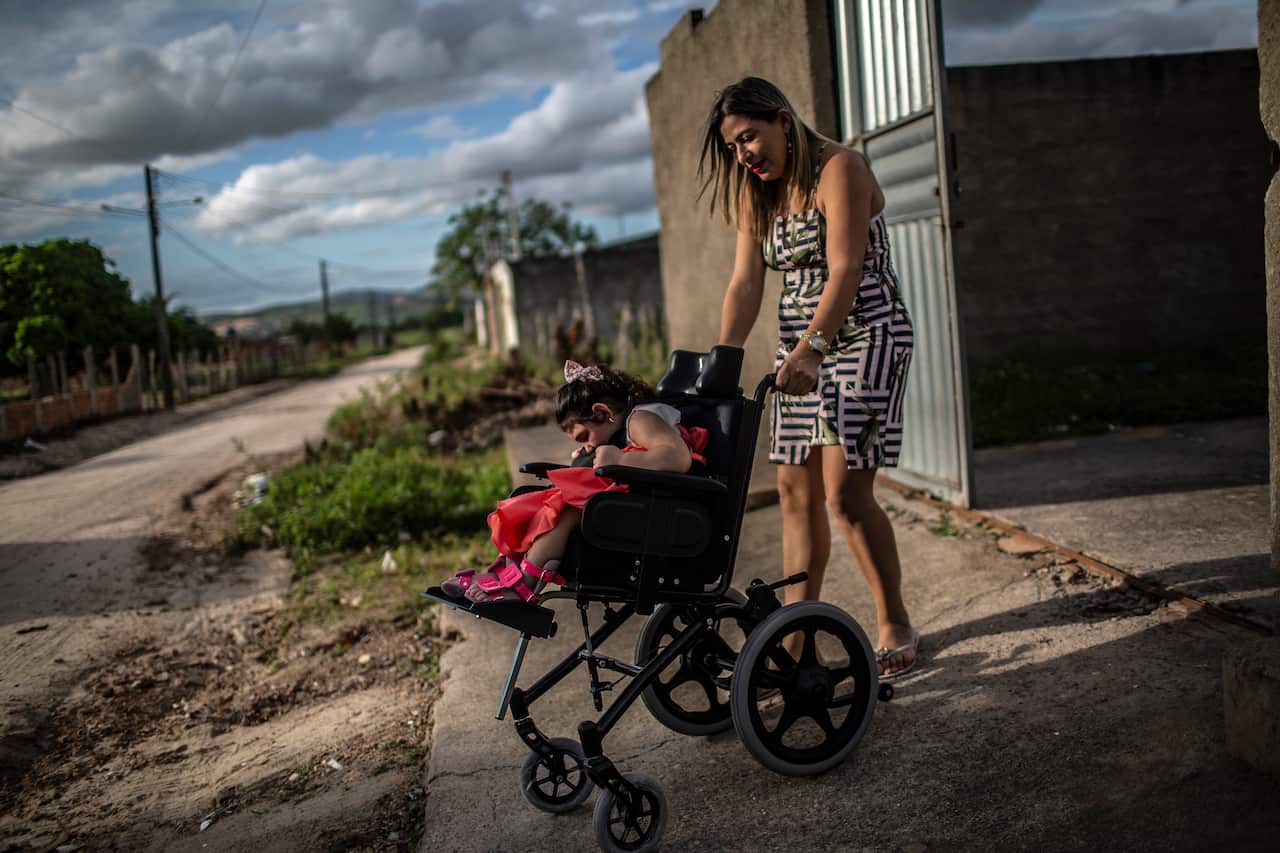 Gisleangela Oliveira dos Santos leaves her home with her daughter, who suffers from microcephaly, in Girau do Ponciano, Brazil, April 26, 2019. (Dado Galdieri/The New York Times)