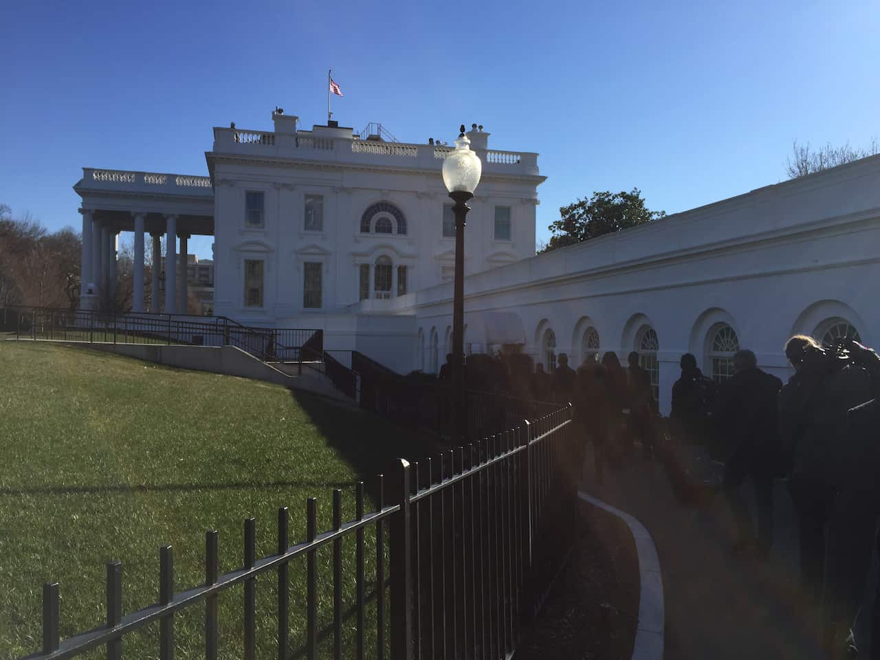 SBS News's Brett Mason walks up to the White House in Washington.